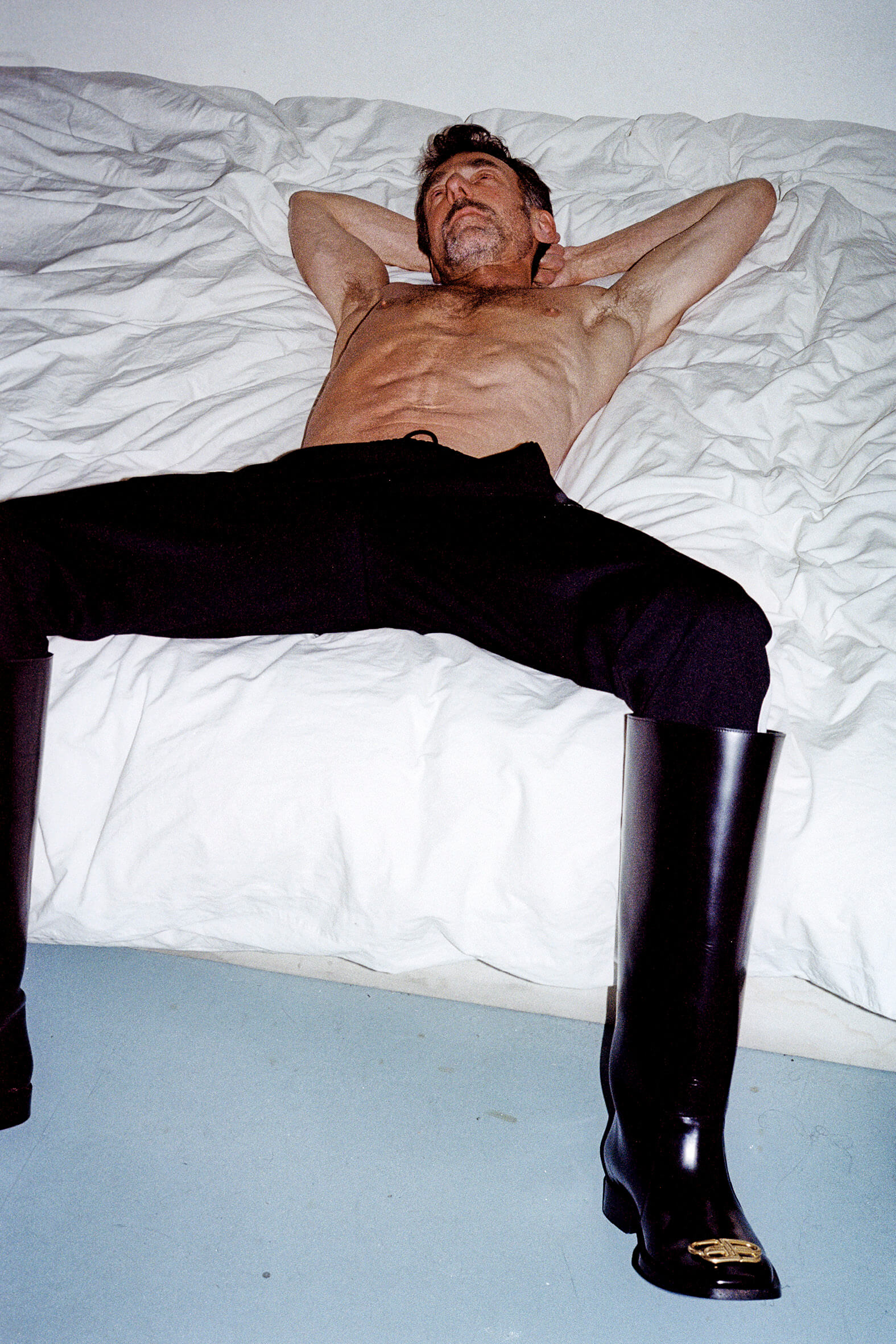 MASSES Magazine No. 12 – Aux Armes et Cætera, Photography by Matthias Vriens — Alain Gossuin wearing Balenciaga by Demna Gvasalia Autumn/Winter 2019 rain BB boots – 2019